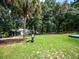 Home with a spacious backyard, lush landscaping, and a motorbike at 24750 Ne 177Th Ter, Fort Mc Coy, FL 32134