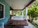 Relaxing porch with a swing and wooden table at 24750 Ne 177Th Ter, Fort Mc Coy, FL 32134
