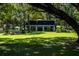 Home with a large backyard, lush landscaping, and a large tree at 24750 Ne 177Th Ter, Fort Mc Coy, FL 32134