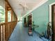 Long screened porch with rocking chair, small table, and wooded view at 24750 Ne 177Th Ter, Fort Mc Coy, FL 32134