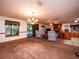 Open living room and kitchen with a fireplace and lots of natural light at 24750 Ne 177Th Ter, Fort Mc Coy, FL 32134