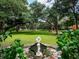 Landscaped backyard with a pond and large trees at 24750 Ne 177Th Ter, Fort Mc Coy, FL 32134