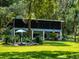 House with a screened-in porch and a pond feature in the backyard at 24750 Ne 177Th Ter, Fort Mc Coy, FL 32134