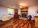 Basement living area with wood flooring, stone fireplace, and built-in corner cabinet at 24750 Ne 177Th Ter, Fort Mc Coy, FL 32134