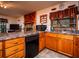 Cozy kitchen features wood cabinets, a dishwasher, and a stone-look countertop at 24750 Ne 177Th Ter, Fort Mc Coy, FL 32134