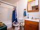 Bathroom with tub shower, wood vanity, and a blue shower curtain at 24750 Ne 177Th Ter, Fort Mc Coy, FL 32134