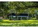 House with screened porch and lush lawn, nestled in a wooded setting at 24750 Ne 177Th Ter, Fort Mc Coy, FL 32134