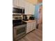 Kitchen with stainless steel appliances and white cabinets at 6995 Se 22Nd Ave, Ocala, FL 34480