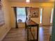 Simple dining area with a long wooden table and access to the front door at 6995 Se 22Nd Ave, Ocala, FL 34480