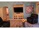 Living room with built-in shelving and large TV at 6995 Se 22Nd Ave, Ocala, FL 34480