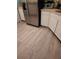 Kitchen features stainless steel refrigerator and light wood laminate flooring at 6995 Se 22Nd Ave, Ocala, FL 34480