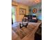 Living room with leather couches, glass coffee table, and wood-look flooring at 6995 Se 22Nd Ave, Ocala, FL 34480