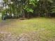 Spacious backyard with wooden table and chairs, surrounded by trees at 6995 Se 22Nd Ave, Ocala, FL 34480