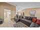 Spacious living room featuring a large sectional sofa and tile floors at 25 Cedar Ter, Ocala, FL 34472