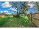 Spacious backyard with grassy area, wooden fence, and large tree at 25 Cedar Ter, Ocala, FL 34472