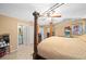 Main bedroom with a large bed and en-suite bathroom at 25 Cedar Ter, Ocala, FL 34472