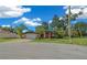 Tan house with orange accents, attached garage, and lush lawn at 25 Cedar Ter, Ocala, FL 34472