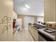 Galley style kitchen with white cabinetry and breakfast bar at 25 Cedar Ter, Ocala, FL 34472
