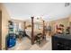 Spacious main bedroom with a four-poster bed and ample storage at 25 Cedar Ter, Ocala, FL 34472