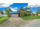 Tan house with orange accents, attached garage, and lush lawn at 25 Cedar Ter, Ocala, FL 34472