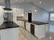 Updated kitchen featuring a large island and wine cooler at 8028 Se 62Nd Ln, Ocala, FL 34472