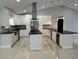 Modern kitchen with large island and stainless steel appliances at 8028 Se 62Nd Ln, Ocala, FL 34472