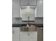Modern kitchen with farmhouse sink and custom cabinetry at 8028 Se 62Nd Ln, Ocala, FL 34472