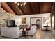 Bright living room with vaulted ceilings, stone wall, and ample seating at 12750 W Highway 40, Ocala, FL 34481