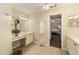 Main bathroom with double vanity, tile floors, and access to bedroom at 6470 Sw 50Th Ct, Ocala, FL 34474