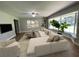 Living room featuring a comfy sectional sofa and large windows at 9526 Sw 72Nd Ct, Ocala, FL 34476