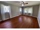 Spacious bedroom with wood-look floors and large windows at 9526 Sw 72Nd Ct, Ocala, FL 34476