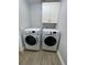 Laundry room with washer, dryer, and overhead cabinets at 9526 Sw 72Nd Ct, Ocala, FL 34476