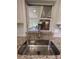 Kitchen sink with granite countertop and view of backyard patio at 9526 Sw 72Nd Ct, Ocala, FL 34476