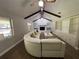 Bright living room features a white sectional sofa, built-in shelving, and hardwood floors at 9526 Sw 72Nd Ct, Ocala, FL 34476