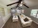 Open living room with hardwood floors, white sectional sofa, and views into kitchen area at 9526 Sw 72Nd Ct, Ocala, FL 34476