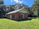 Brick building with black shutters and a spacious yard at 9526 Sw 72Nd Ct, Ocala, FL 34476