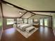 Main bedroom with hardwood floors, a king-size bed, and access to the backyard at 9526 Sw 72Nd Ct, Ocala, FL 34476
