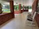Inviting front porch with rocking chairs and a swing, perfect for relaxing at 9526 Sw 72Nd Ct, Ocala, FL 34476