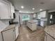 Spacious kitchen with island, granite countertops, and white cabinets at 9526 Sw 72Nd Ct, Ocala, FL 34476