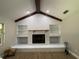 White brick fireplace with built-in shelving and hardwood floors at 9526 Sw 72Nd Ct, Ocala, FL 34476