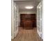 Home office with built-in shelving and wood floors at 9526 Sw 72Nd Ct, Ocala, FL 34476