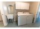 Laundry room with washer, dryer, cabinets, and utility sink at 1331 Se 169Th Terrace Rd, Silver Springs, FL 34488
