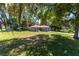 Single story home nestled among trees with a red metal roof and gray siding at 1331 Se 169Th Terrace Rd, Silver Springs, FL 34488