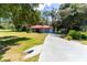 Single story home with red metal roof, gray siding, and a long driveway at 1331 Se 169Th Terrace Rd, Silver Springs, FL 34488
