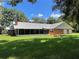 Brick ranch house with a screened porch and picnic table at 9526 Sw 72Nd Ct, Ocala, FL 34476