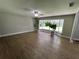 Bright living room with hardwood floors and large windows at 9526 Sw 72Nd Ct, Ocala, FL 34476