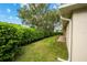 Landscaped backyard with a lush green lawn and hedge at 6470 Sw 50Th Ct, Ocala, FL 34474