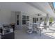 Covered patio with outdoor dining table and grill at 5615 Nw 202Nd Pl, Mc Intosh, FL 32664