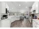 Modern kitchen with white cabinets, marble countertops, and stainless steel appliances at 5615 Nw 202Nd Pl, Mc Intosh, FL 32664