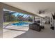 Relaxing pool area with covered patio, lounge furniture, and a screened enclosure at 5615 Nw 202Nd Pl, Mc Intosh, FL 32664